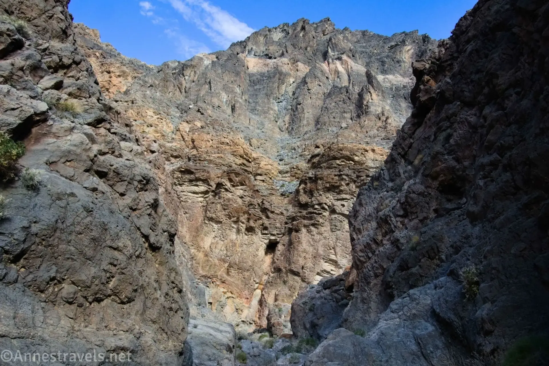 Beyond the Slit Rocky walls tower over a desert canyon
