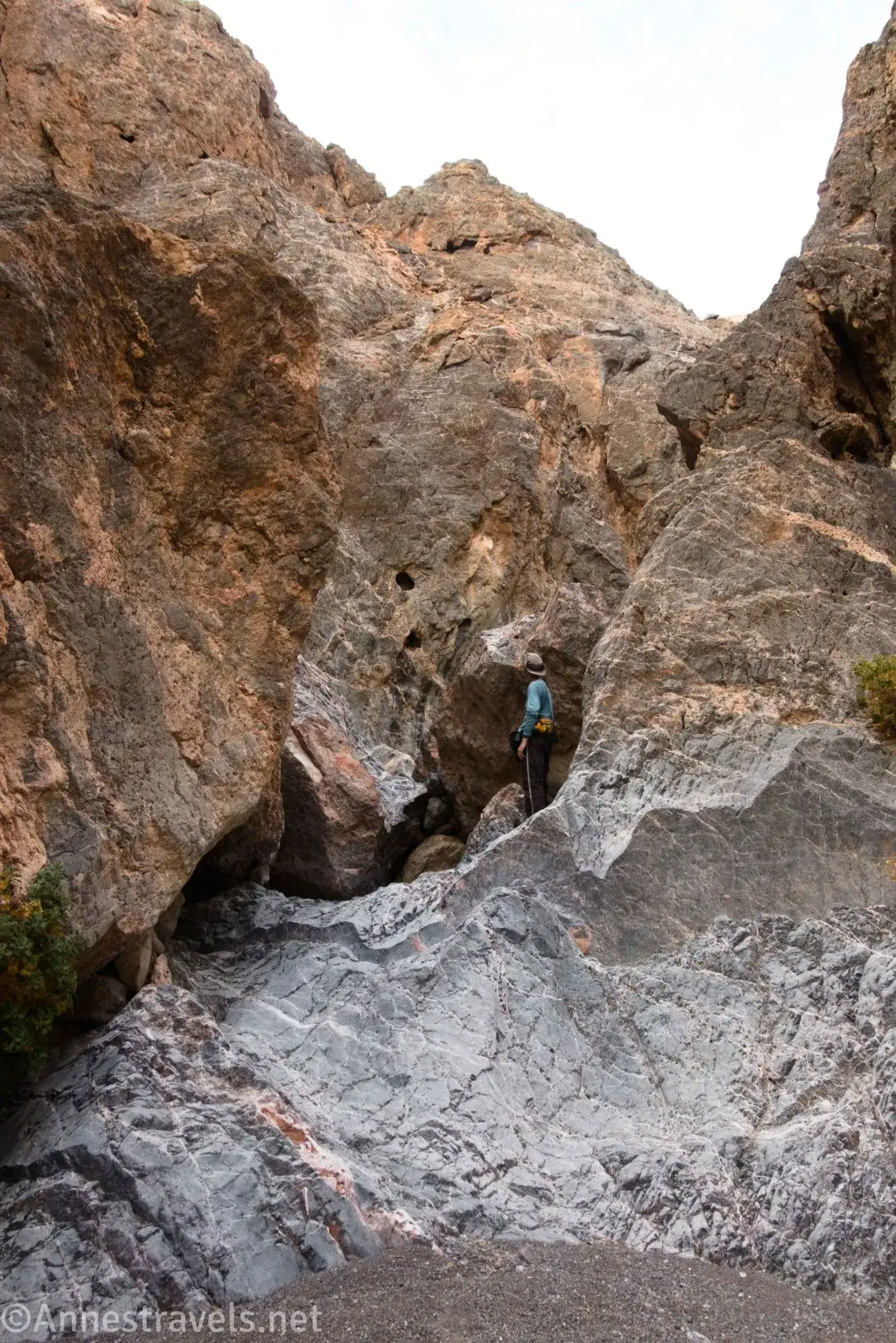Larger Dryfall A hiker stands atop a rocky dryfall below rugged rocks