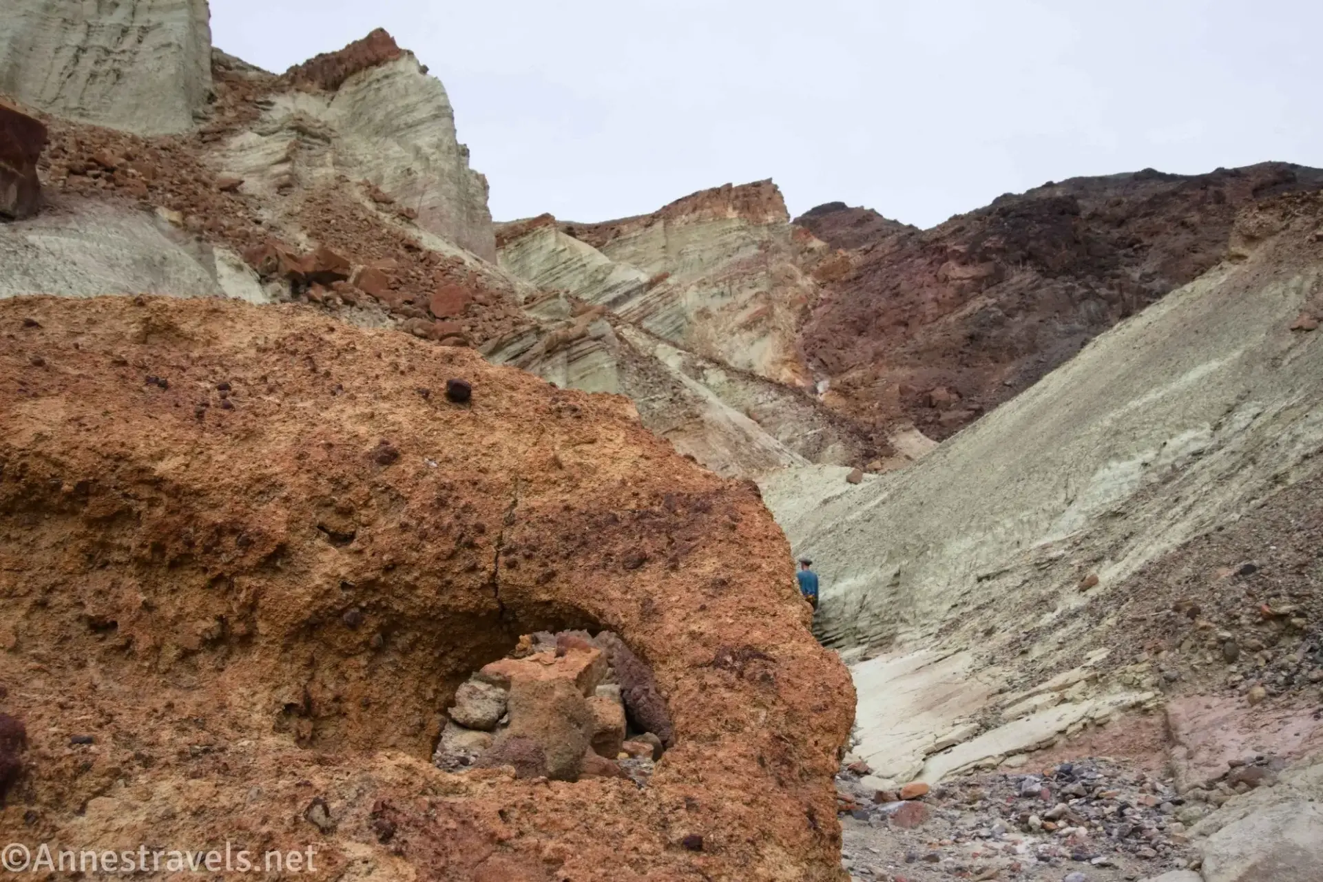 Little Arch in Bryce Fork A small hole in a red rock below badlands