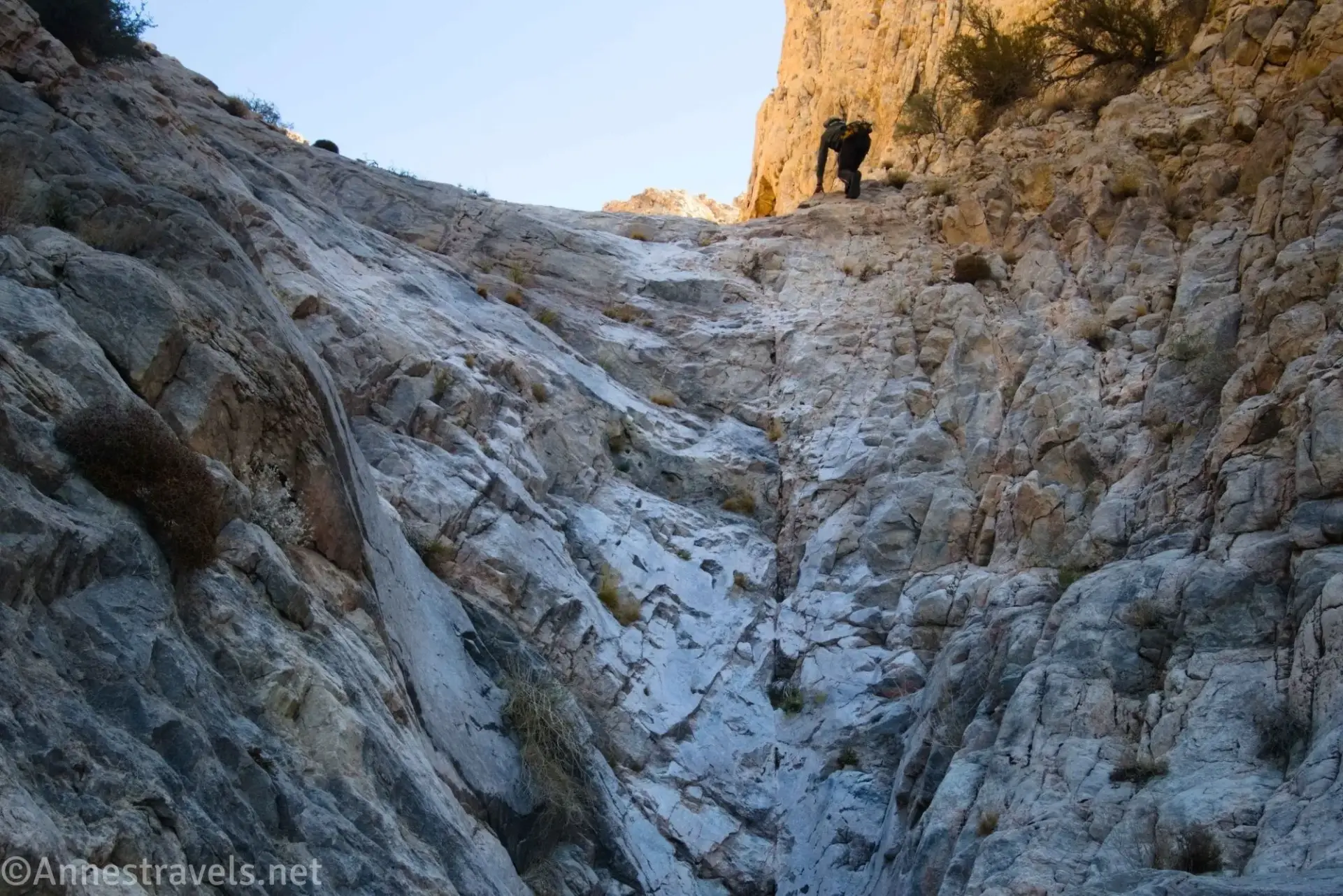 Climbing a Dryfall A hiker climbs a steep cliff