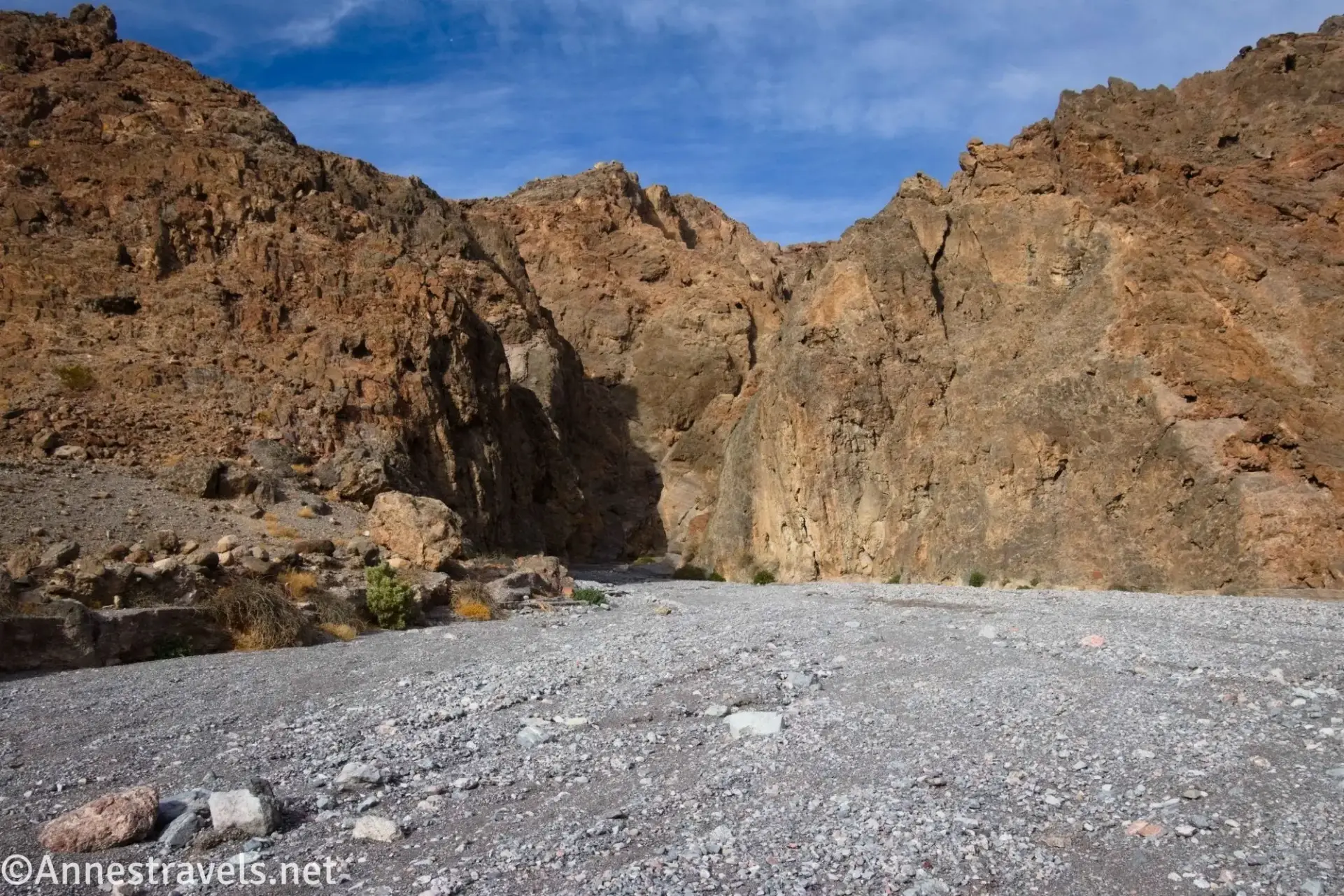 Mouth of Palmer Canyon A gravelly wash leads to brown cliffs of a desert canyon