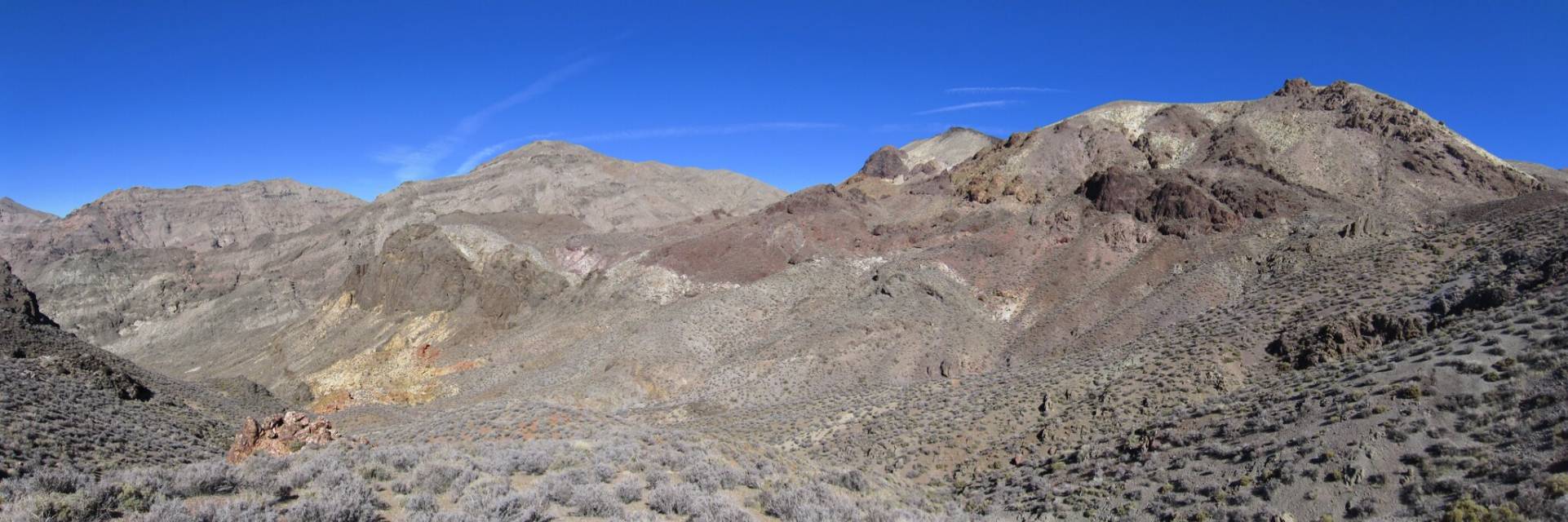 Mountains above Sheep Canyon Colorful red, yellow, and brown mountains rise from a sagebrush valley