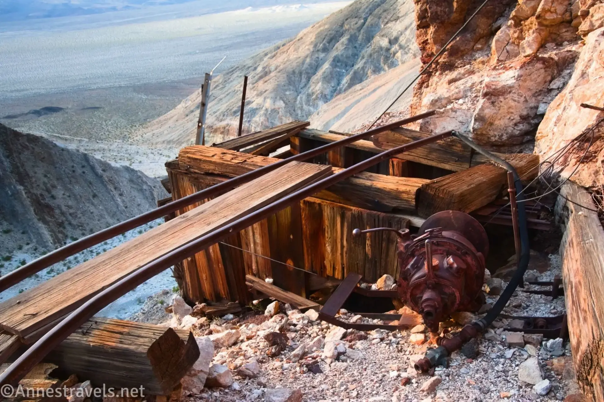 Old Mine Machinery Rusting machinery and railroad tracks on a wooden ore bin above a desert plain