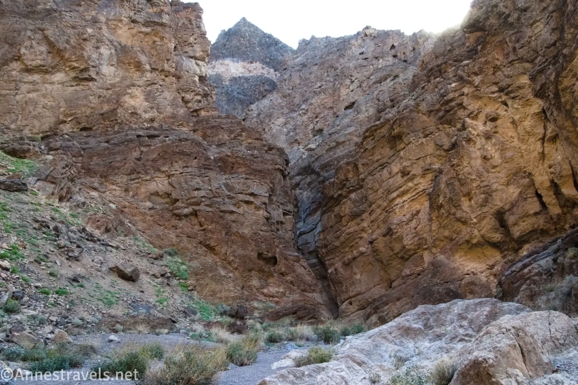 Approaching the Grotto in Slit Canyon Rocky walls close in on a desert canyon with a pointy peak above