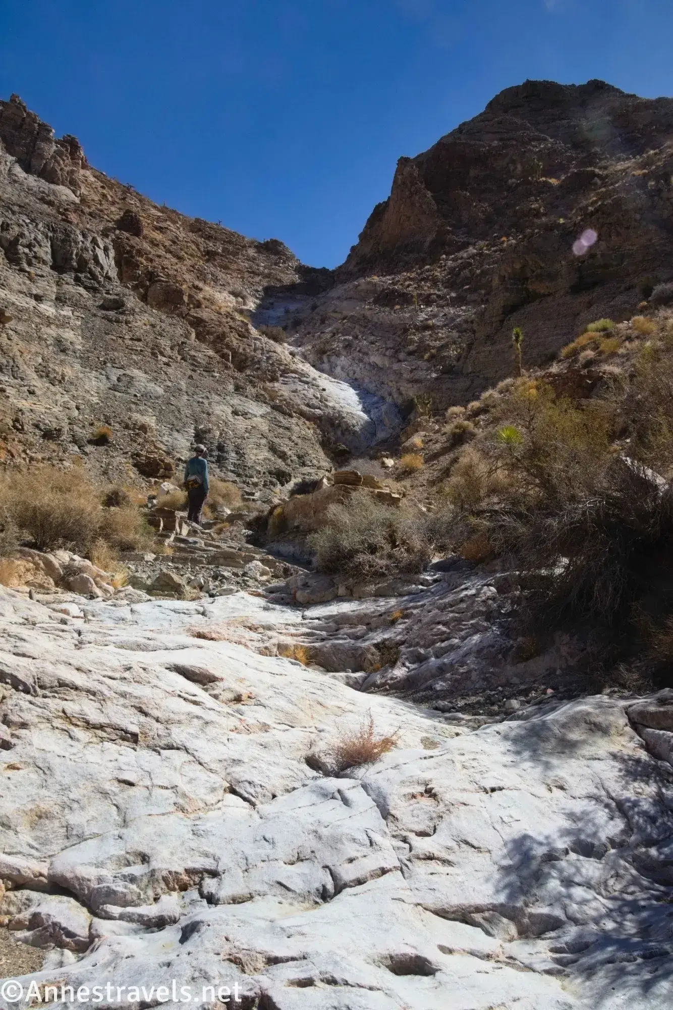 Below a Big Cliff Smooth rocks in a desert canyon