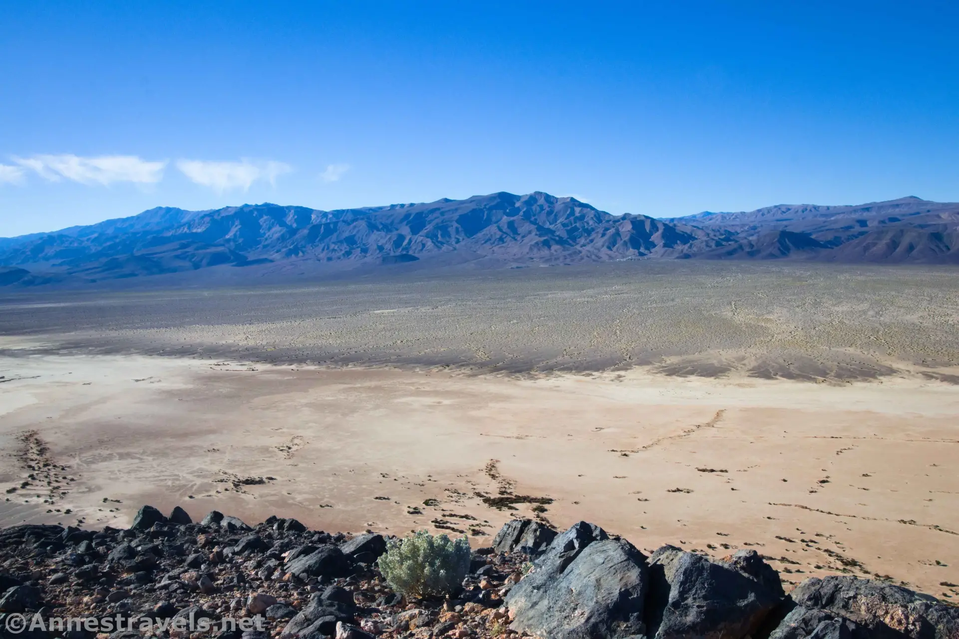 Views West from Lake Hill Rocks on the hillside, playa in the valley, and a desert plain stretching to the mountains