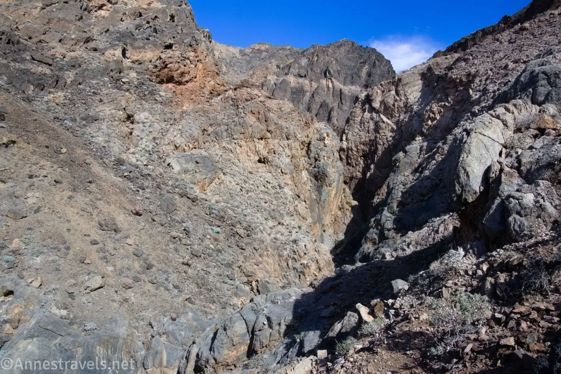 Slit Canyon from the Bypass A rocky, barren hillside with a gorge cutting through it
