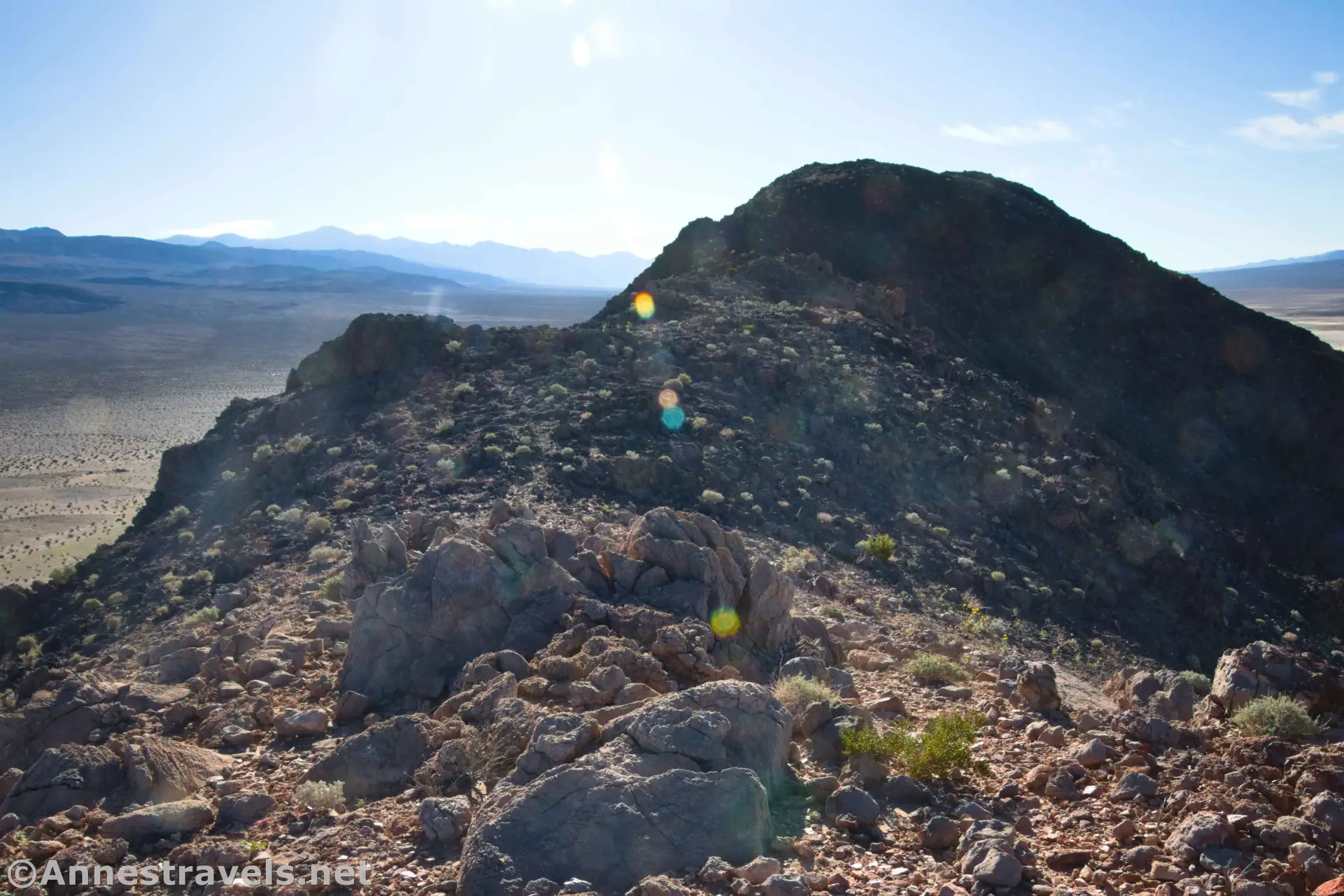 Hiking the Ridgeline rocks on the ridgeline of a hill with distant hazy mountains