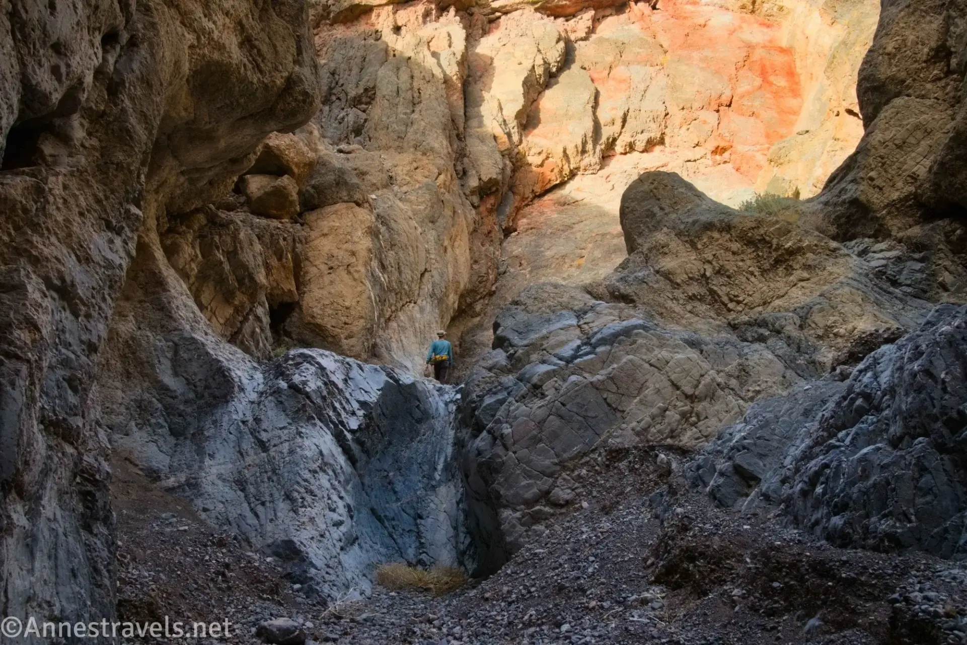 Small Dryfall in Palmer Canyon A hiker above a slick dryfall in a colorful desert canyon