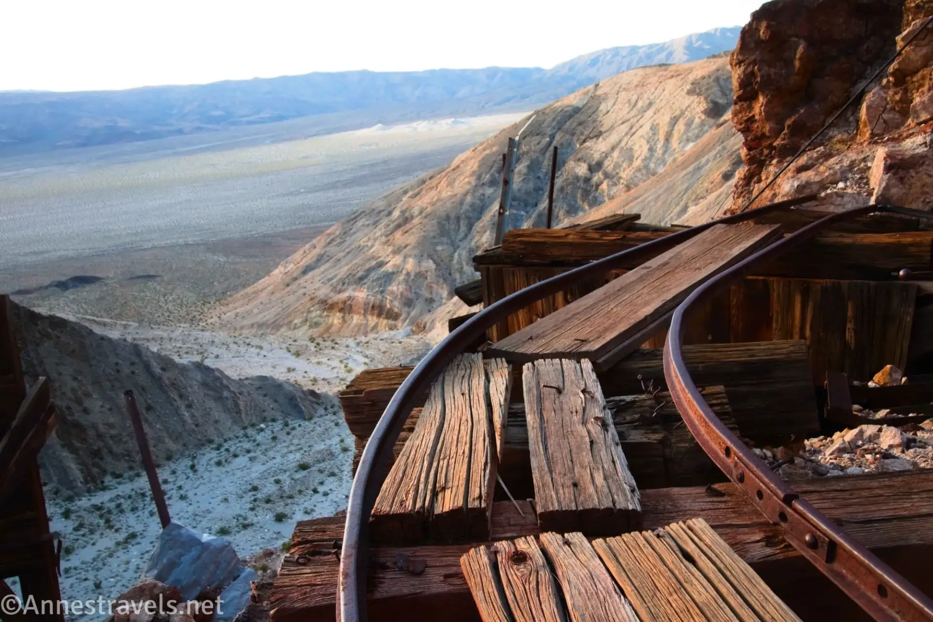 Rail Tracks at the Big 4 Mine Railroad tracks and old wood above a desert canyon with distant desert mountains