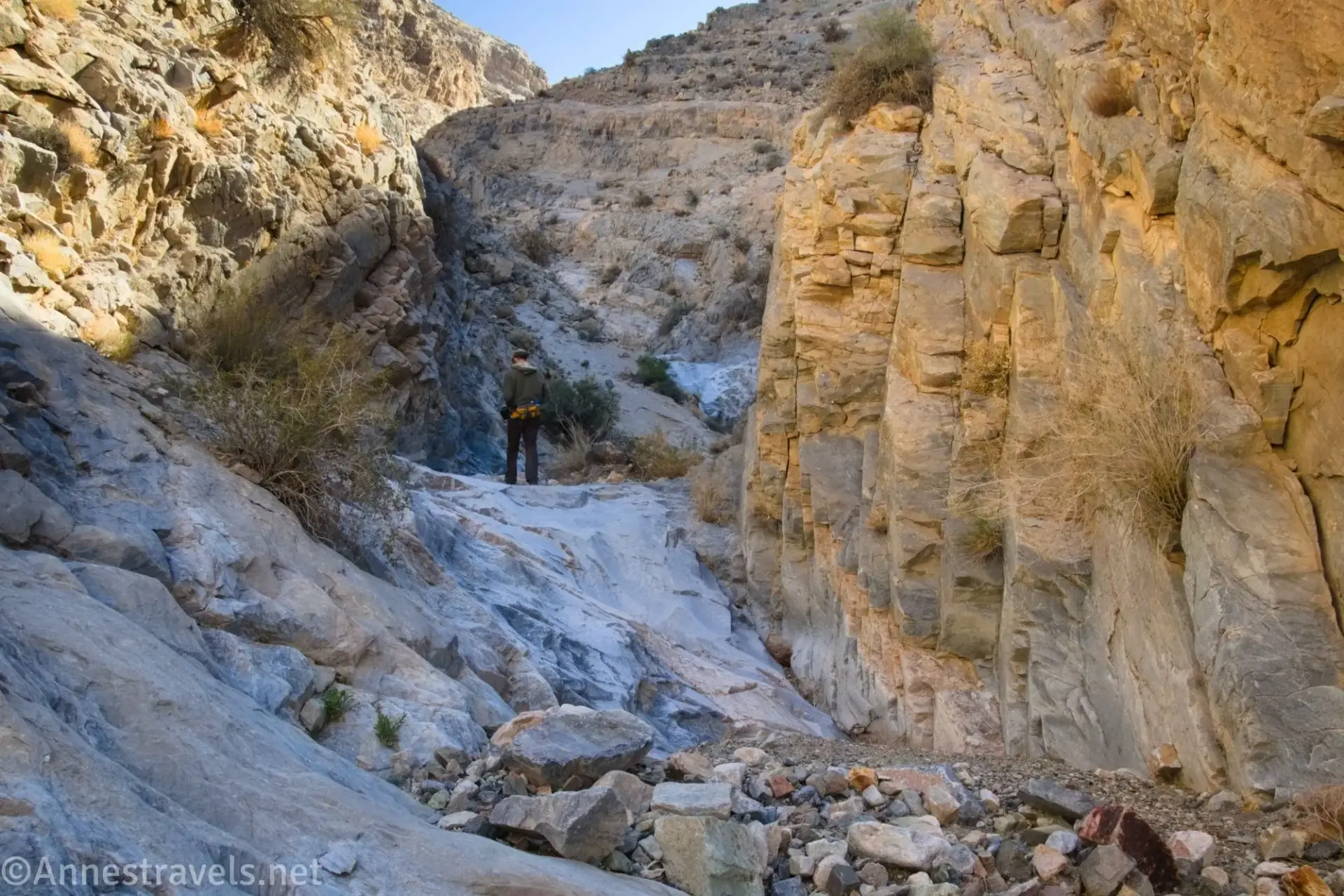A hiker in a rocky desert canyon A hiker in a rocky desert canyon