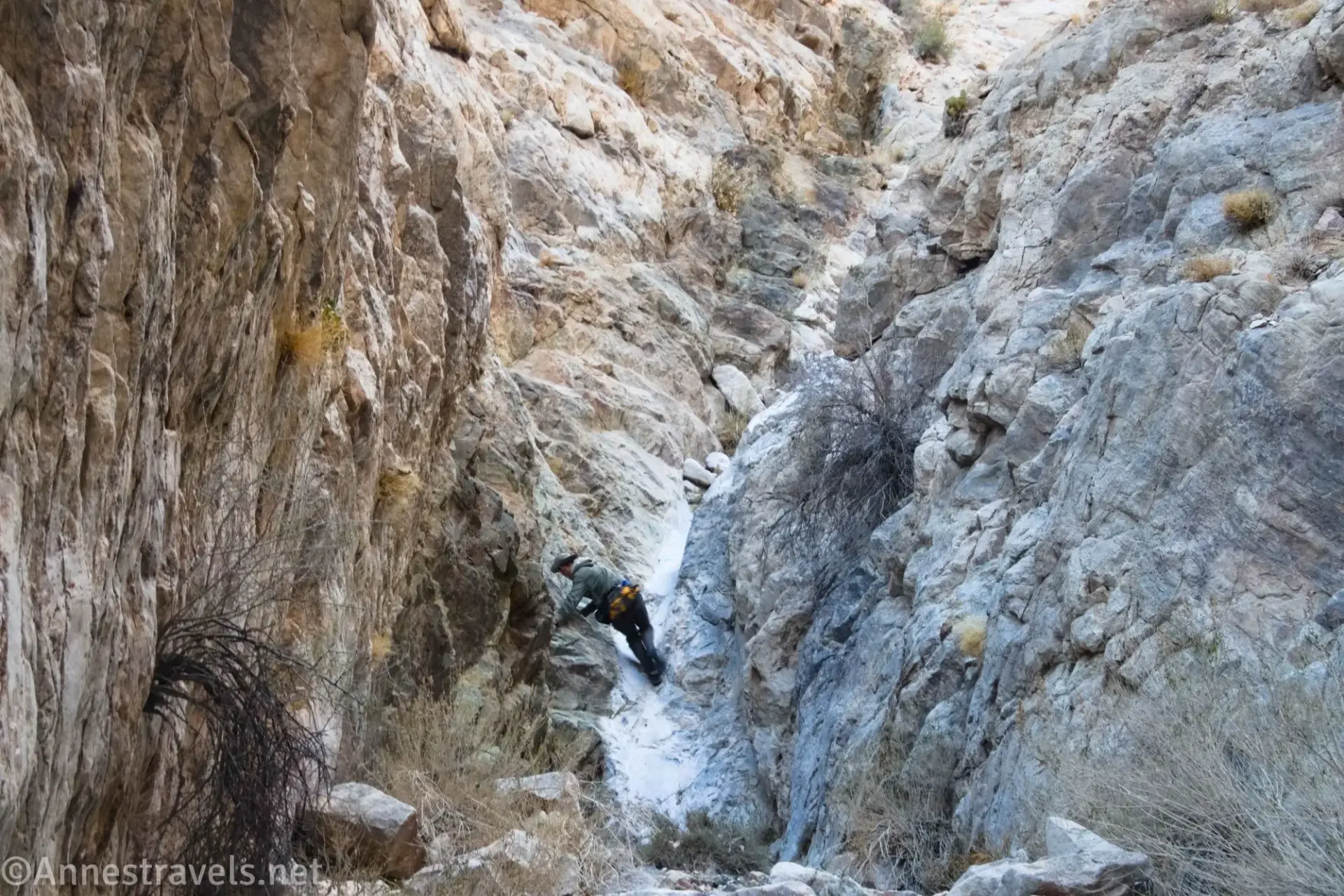 Climbing a Dryfall A hiker climbs a tricky dryfall in a rugged canyon