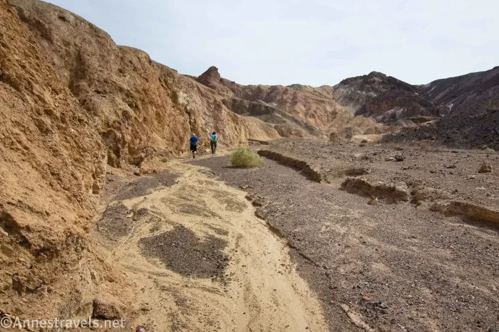 South Fork of Desolation Canyon Wash Gravelly wash with two hikers in blue shirts