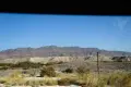 Desert mountains, badlands, and powerlines