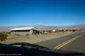 Small building and split rail fence in the desert