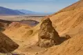 Rock Formation in the South Fork of Desolation Canyon A yellow rock formation in a yellow canyon with distant views to the desert valley and mountains beyond