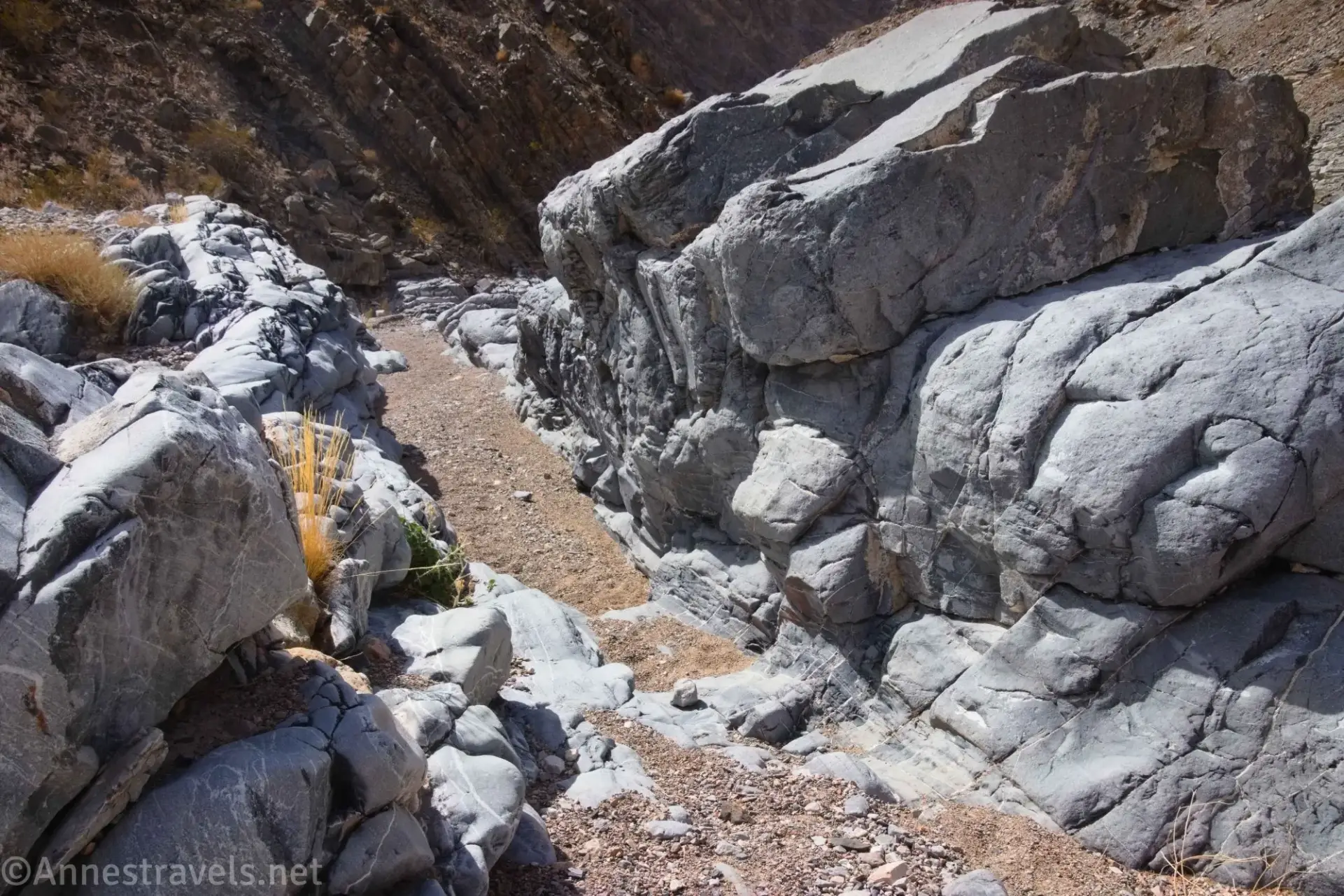 Rocks create a narrow passage in a desert canyon