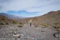 Walking the wash to The Cauldron A hiker walking in a gravel wash with mountains beyond
