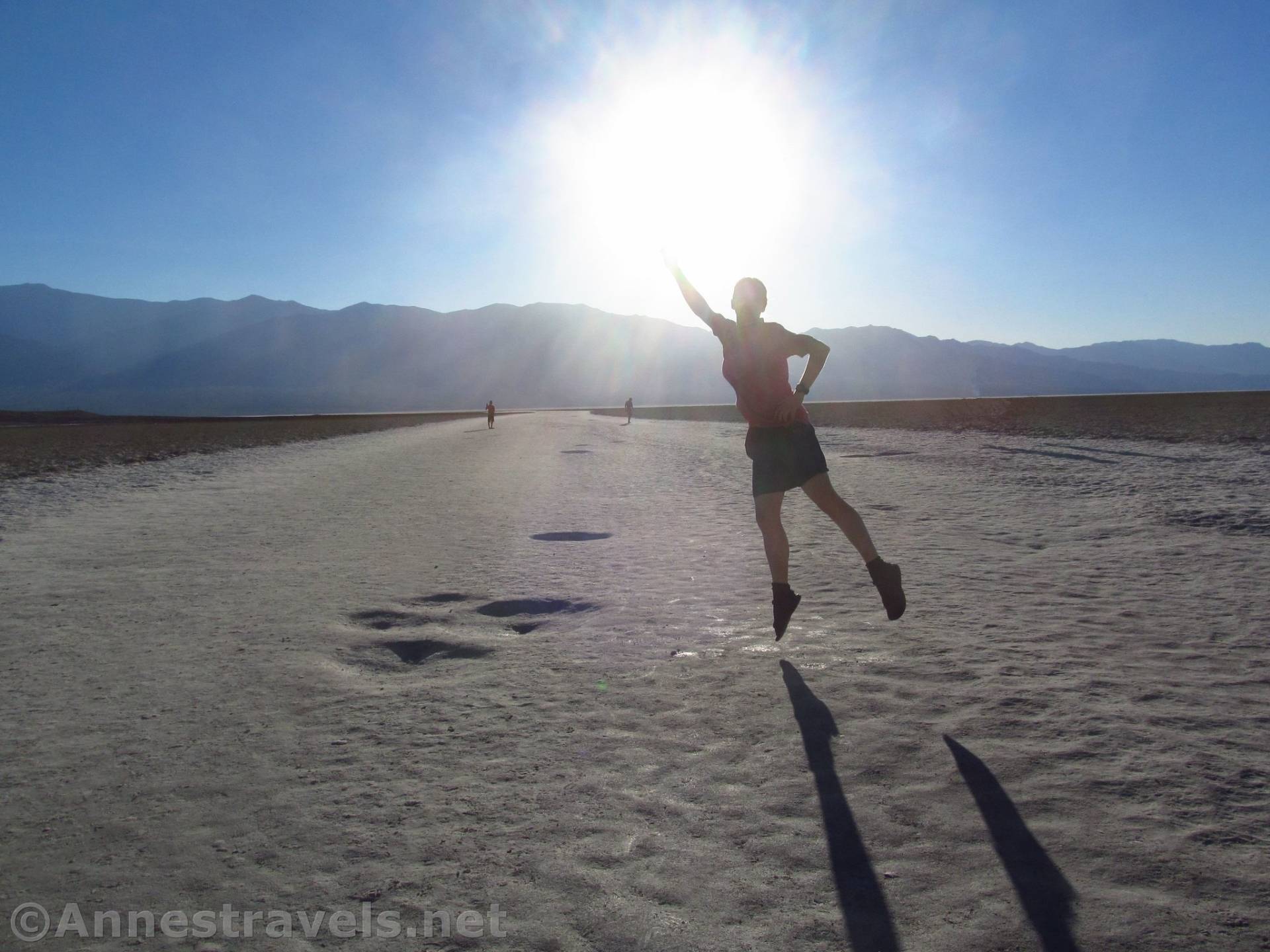Jumping into the sun at Badwater Basin, Death Valley National Park, California