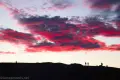 Red and purple clouds over people silhouetted at Zabriskie Point, Death Valley National Park, California