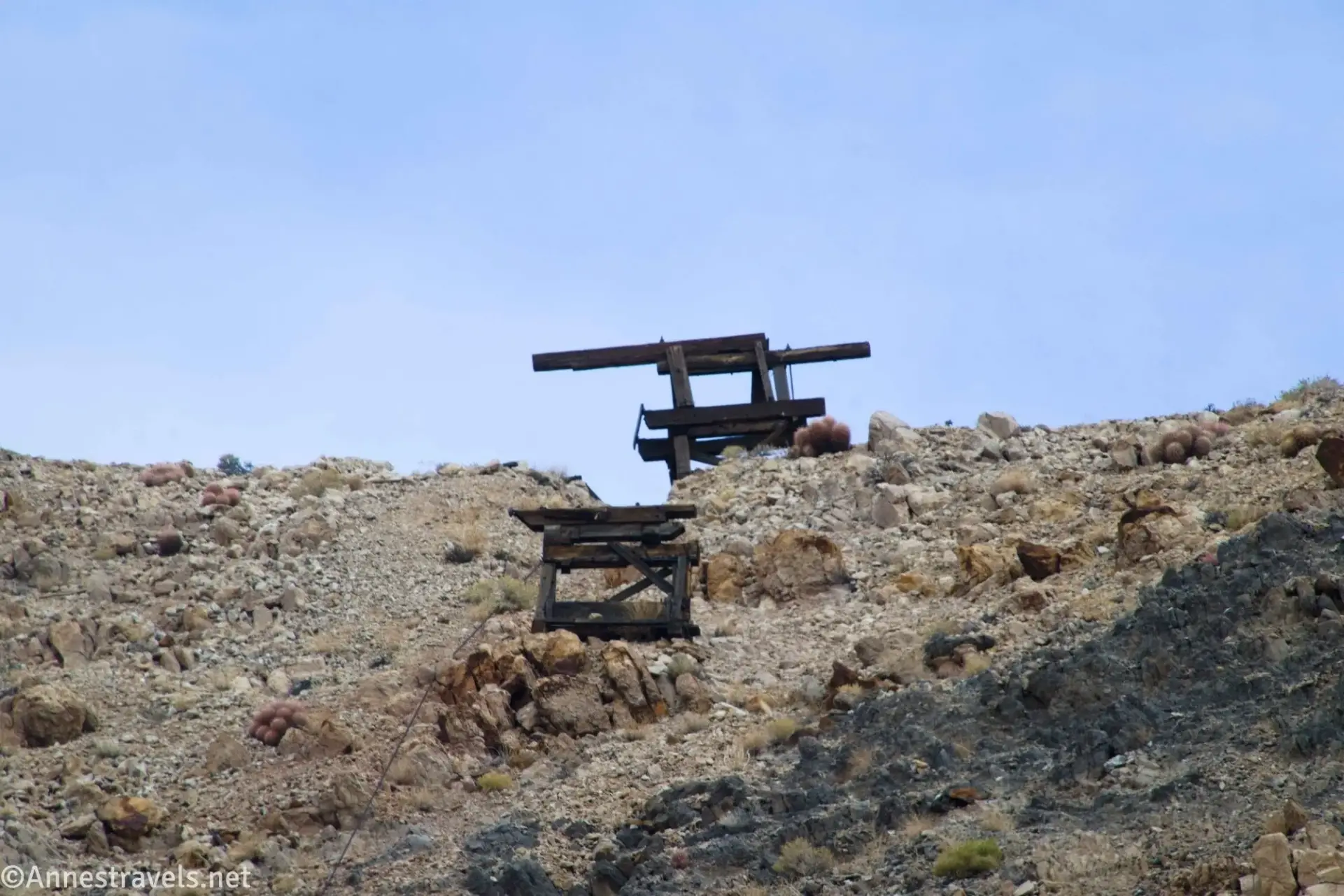 Two wooden towers on a rocky hillside