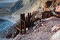 Ruined Ore bin A wooden ore bin and railroad tracks above a rugged desert canyon