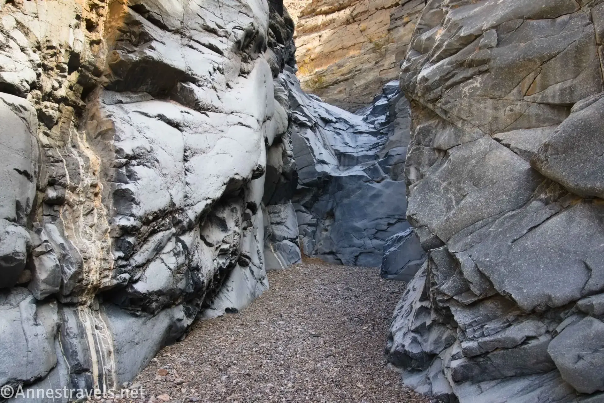 A canyon bounded by rock walls leads to a rock dryfall