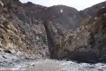 A straight canyon ends at a rocky wall