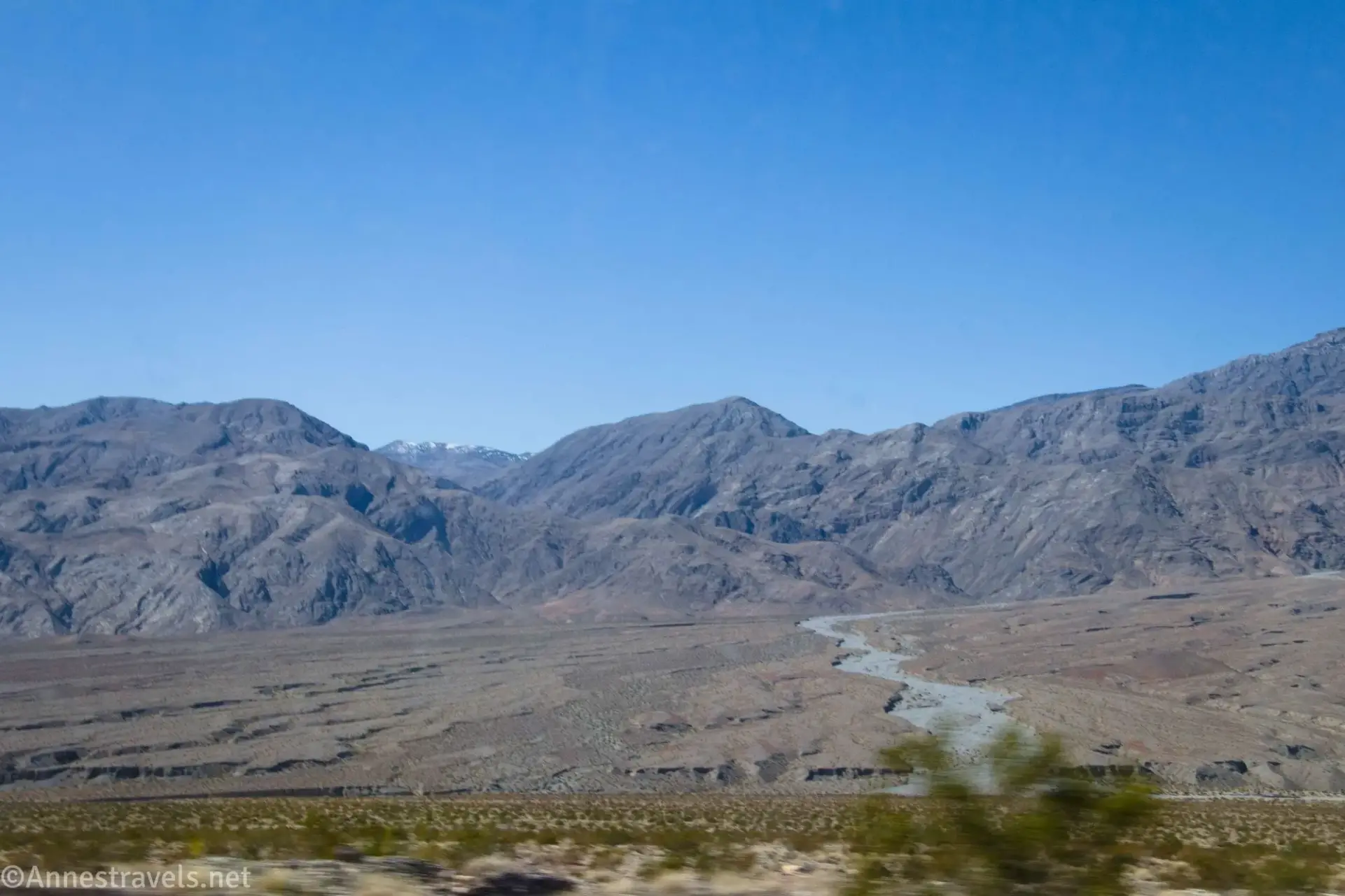 Rocky desert mountains with a gray wash traveling out of th emoutnains