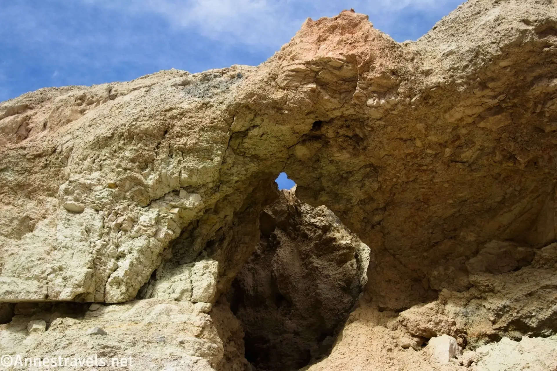A small arch in a yellow rock