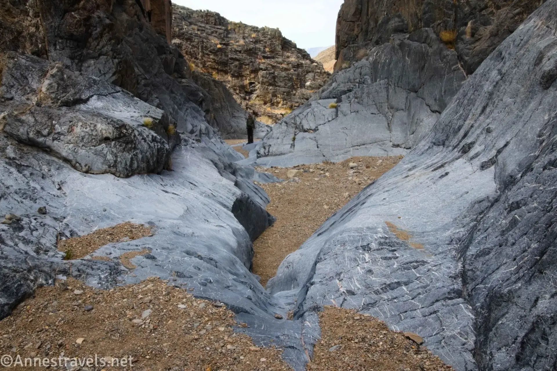 A small dryfall in gray rock between brown gravel