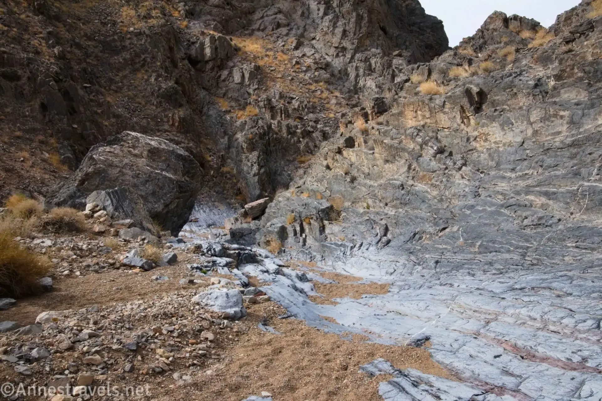 Rock layers above the gravelly wash